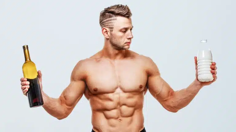 fit guy holding a bottle of alcohol