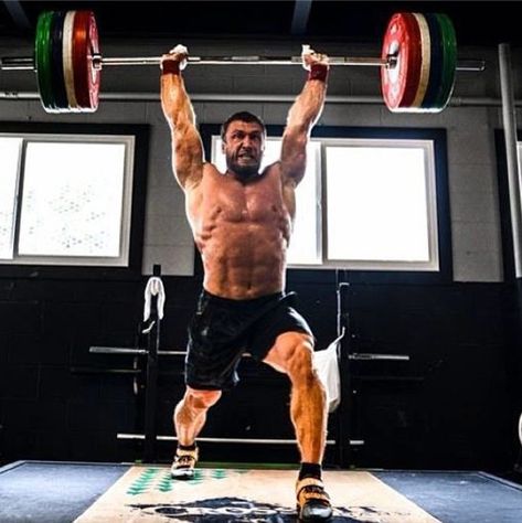 Former Russian powerlifter Dmitry Klokov performing a split jerk in his strength training session.